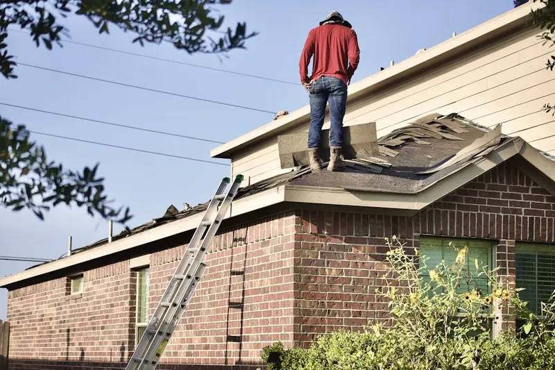 Professional roofer working on a residential roof in Laurel Hills